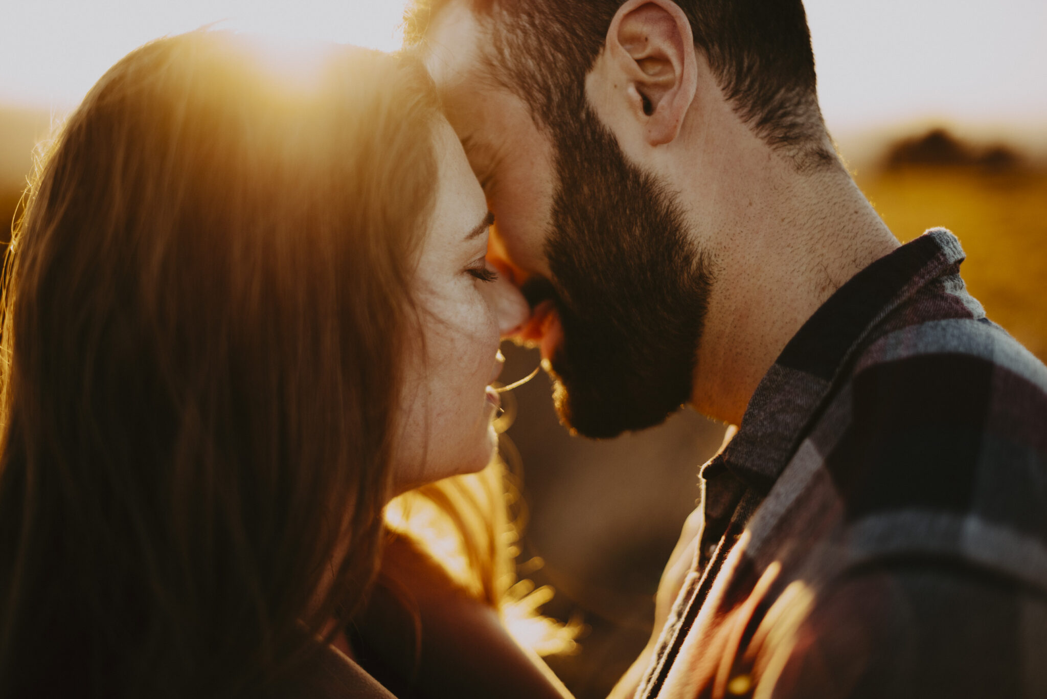 photo de détails d'un couple qui s'embrasse au couchez de soleil avec une lumière dorée, Photo de couple à Brive-la-gaillarde